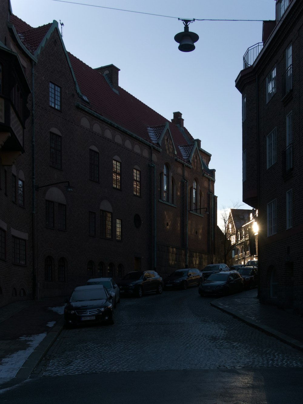 a street with cars parked on the side of it