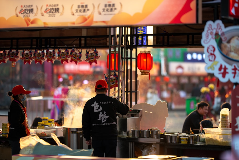 a man standing in front of a food stand