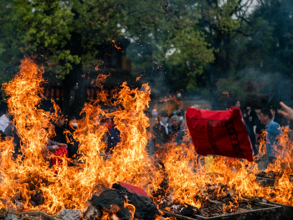 a group of people standing around a fire pit