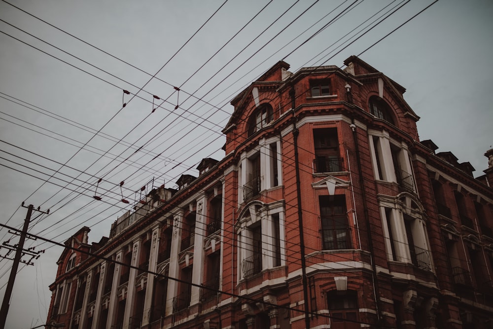 a red brick building with lots of power lines above it