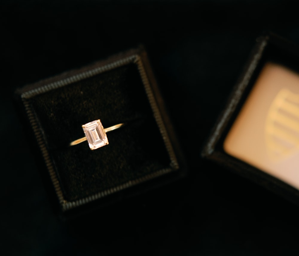 an engagement ring in a box on a table