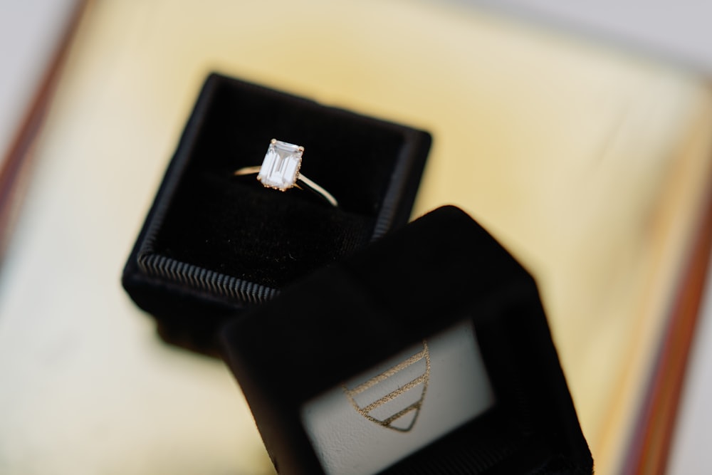 an engagement ring sits on top of a box