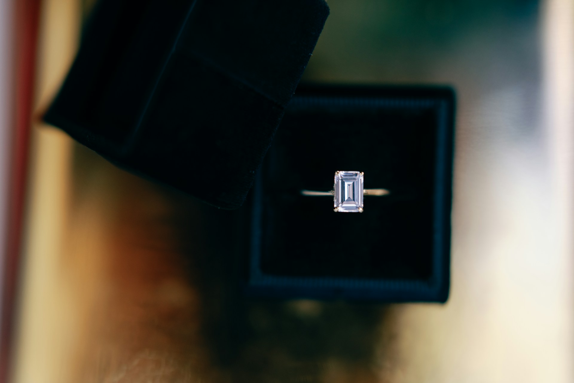 Vintage emerald-cut diamond ring inside a velvet ring box