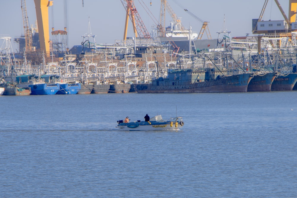 a group of people on a small boat in the water