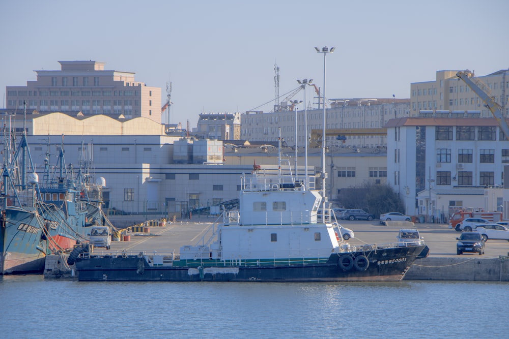 a boat docked in a harbor next to a city