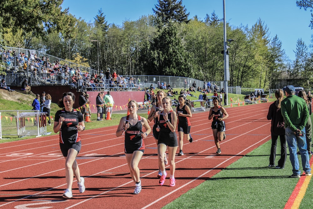 a group of girls running on a track