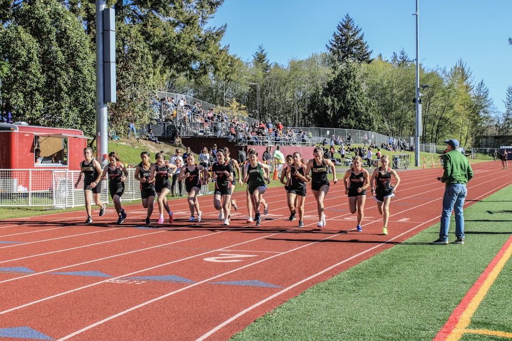 a group of people running on a track