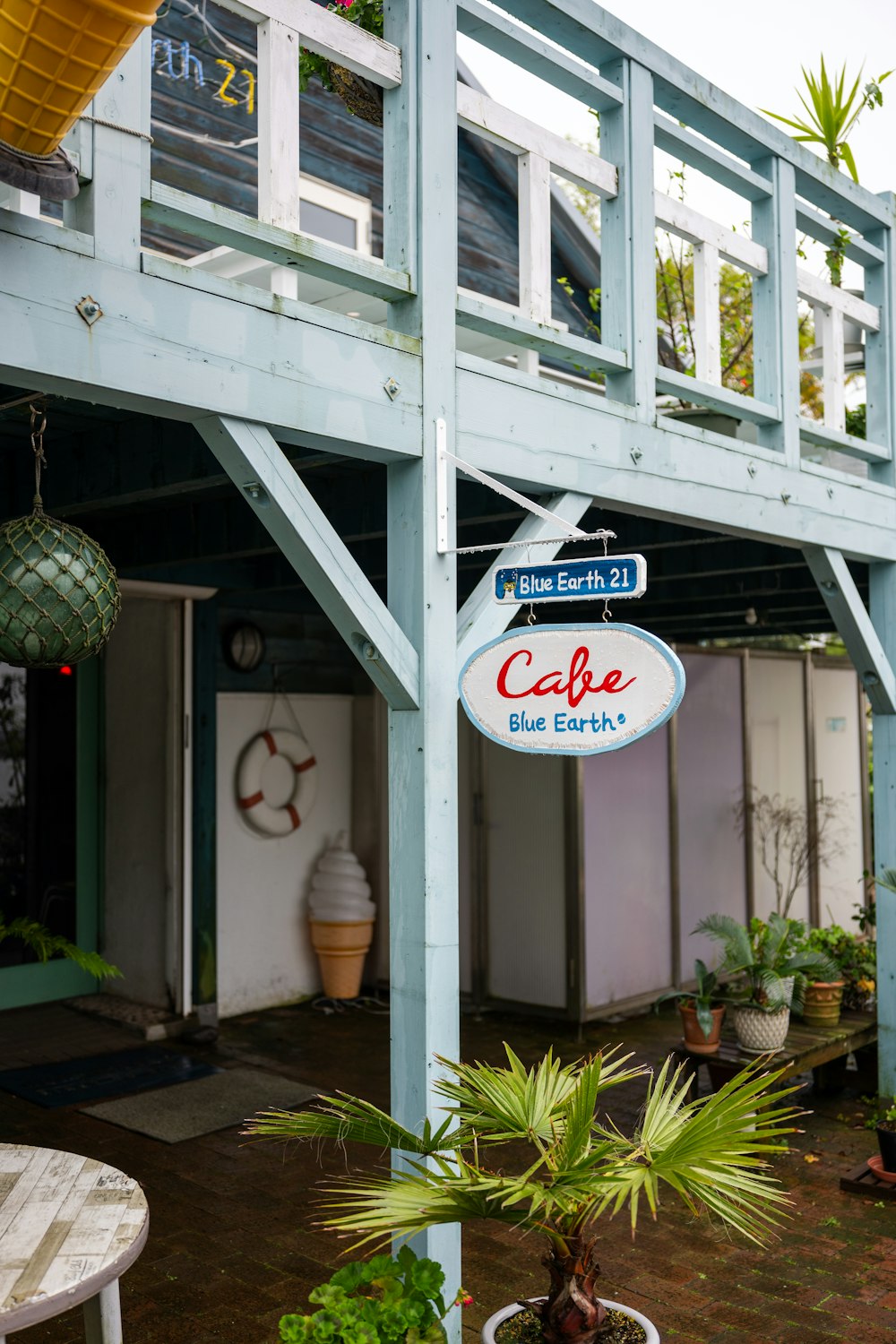 a blue building with a sign that says cafe