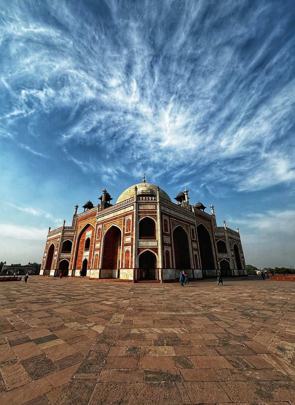 a large building sitting on top of a brick floor