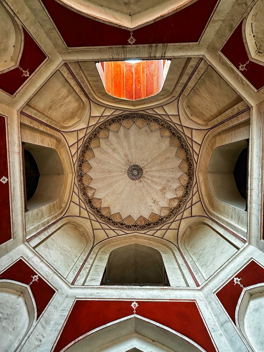 the ceiling of a building with red and white walls