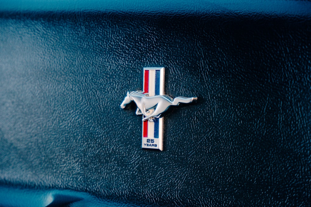 a close up of a horse emblem on a car