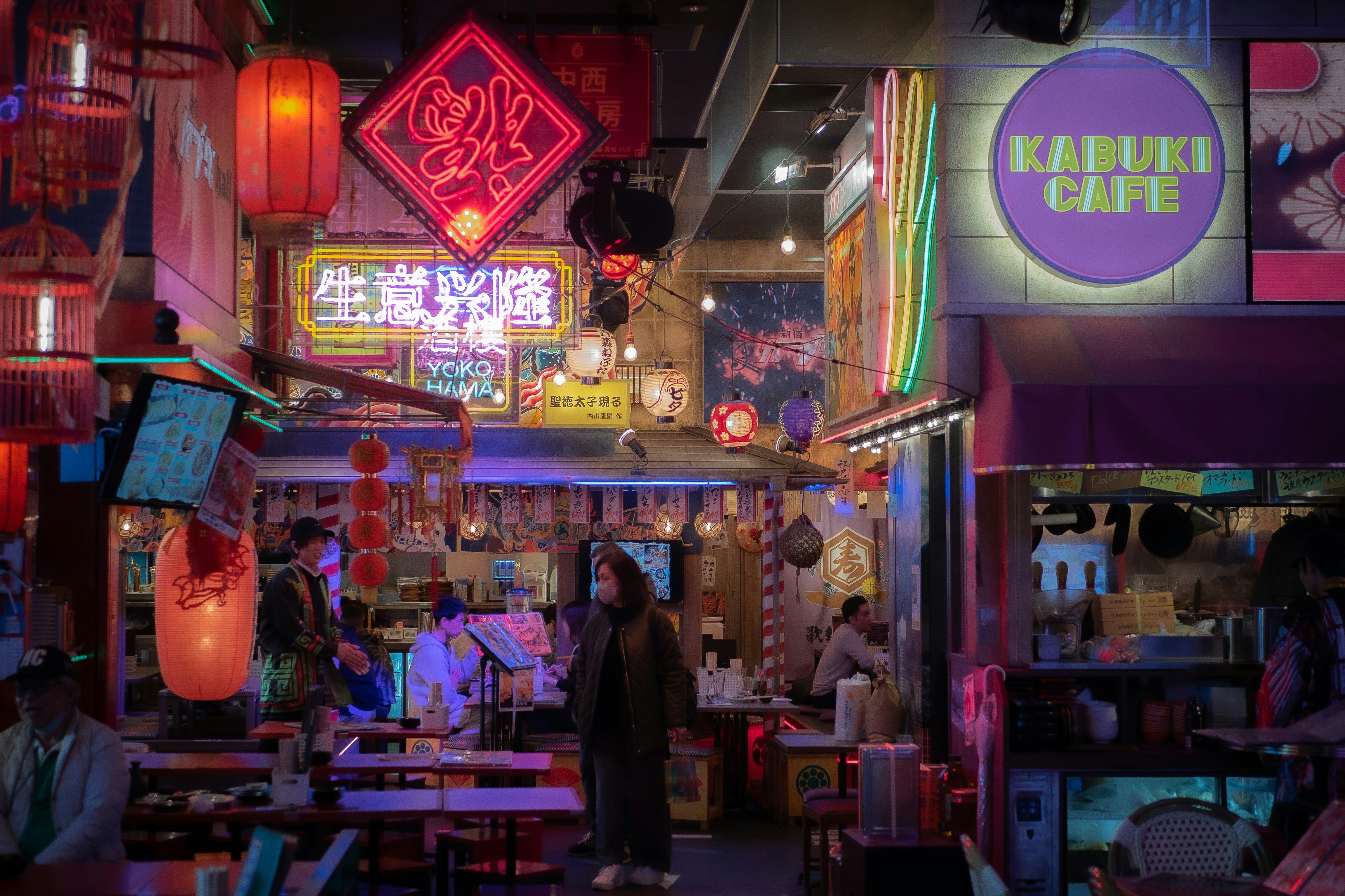 a person standing in a room with neon lights