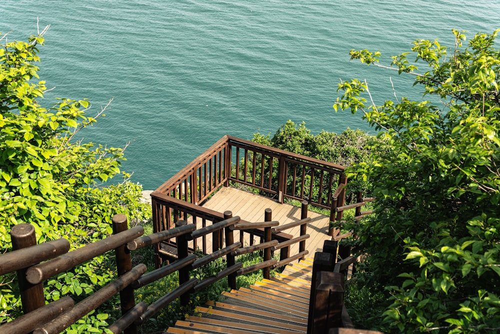 a wooden staircase leading down to a body of water