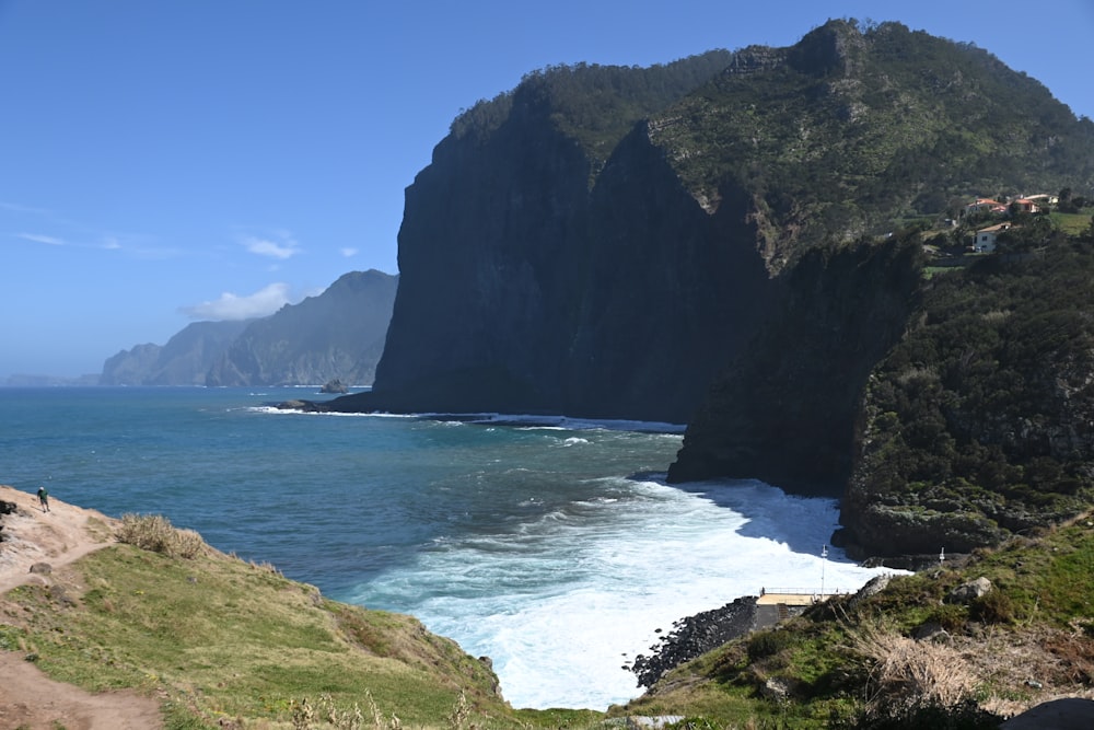 a scenic view of the ocean with a mountain in the background