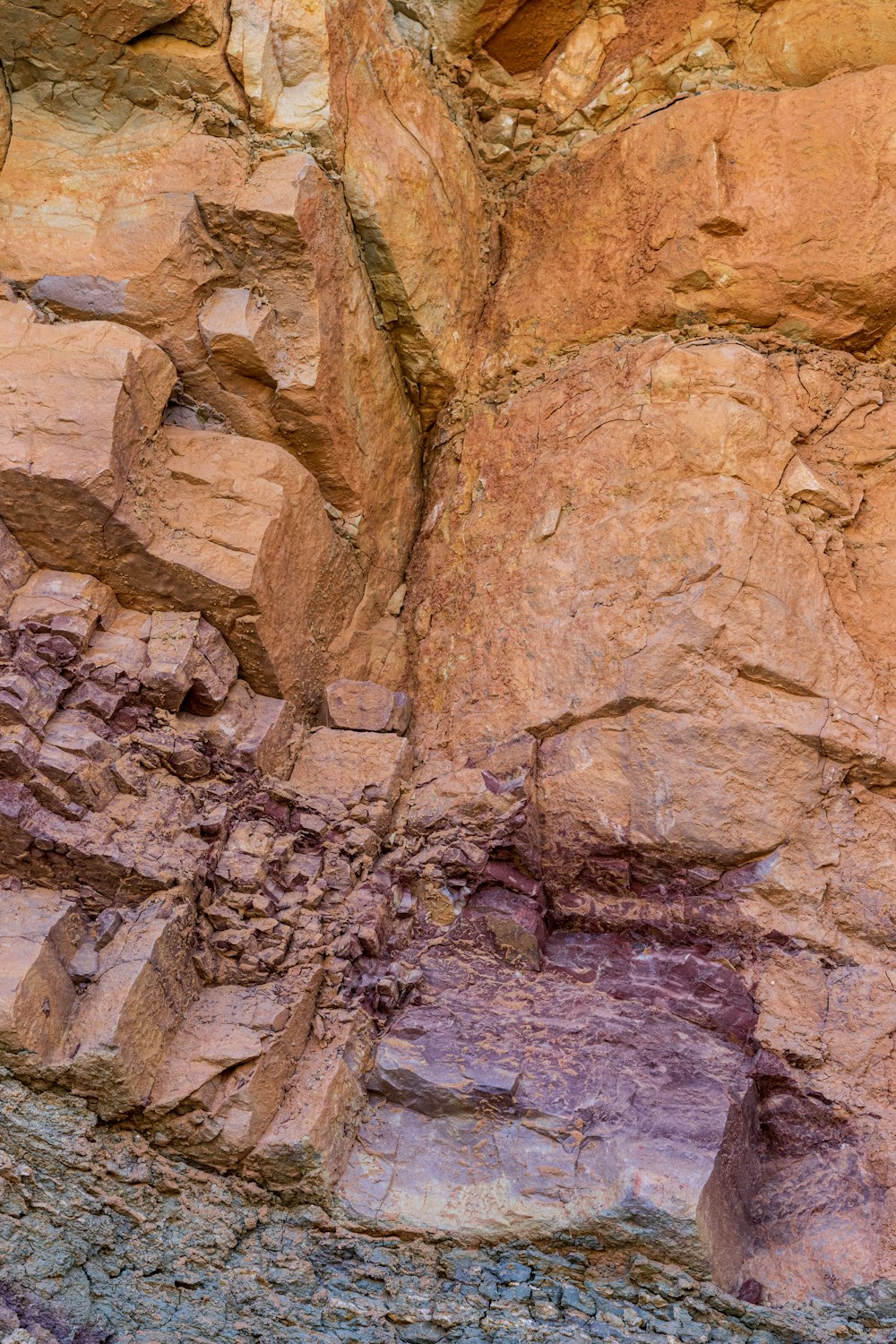 a man standing on a rocky cliff next to a cliff face