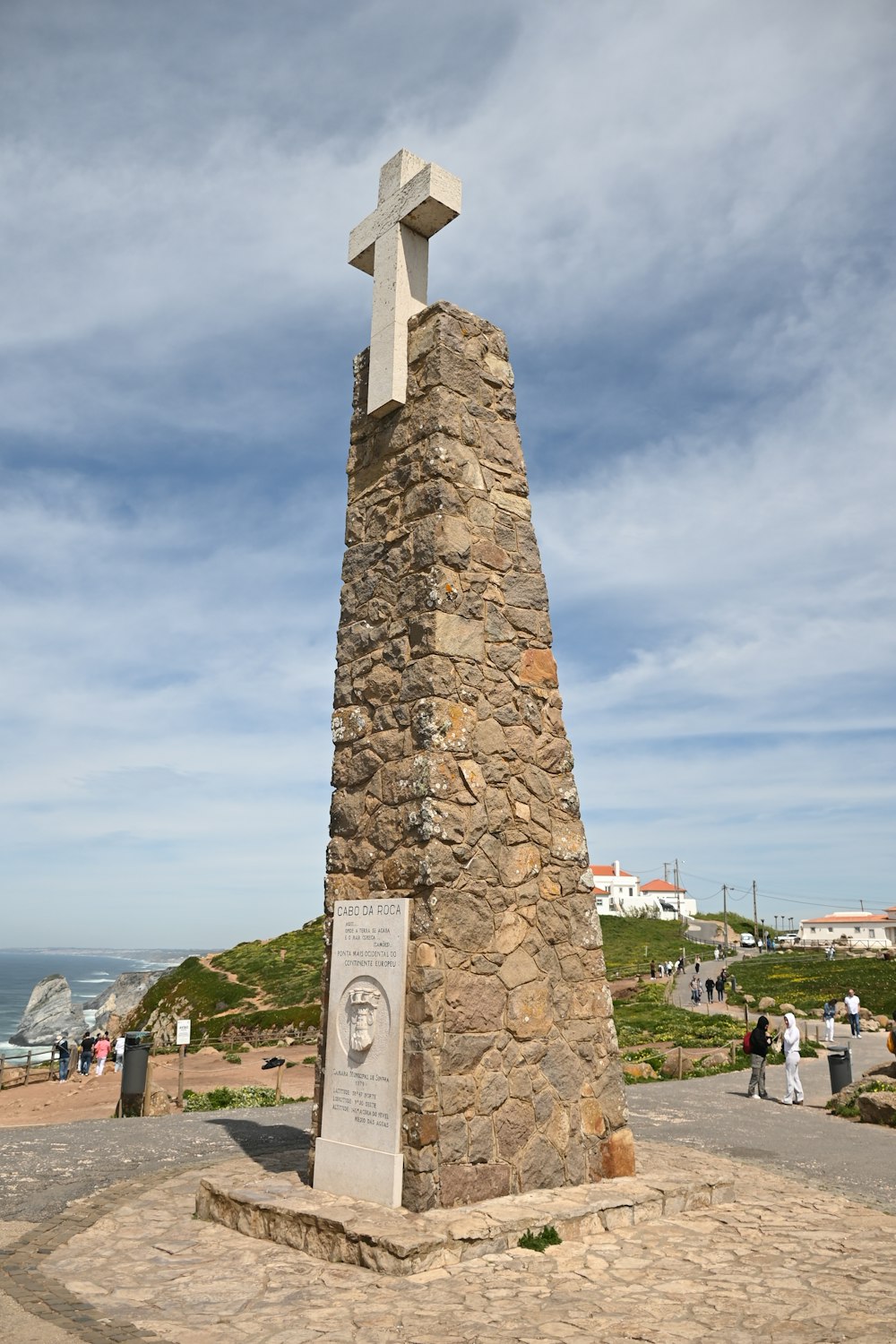 a stone monument with a cross on top of it