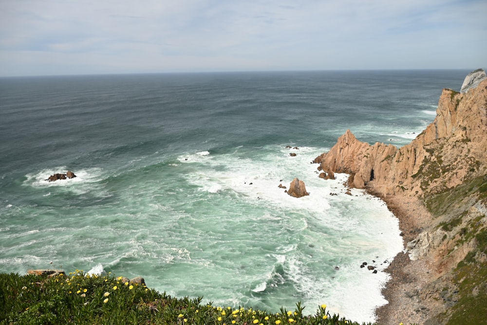 a view of the ocean from the top of a hill