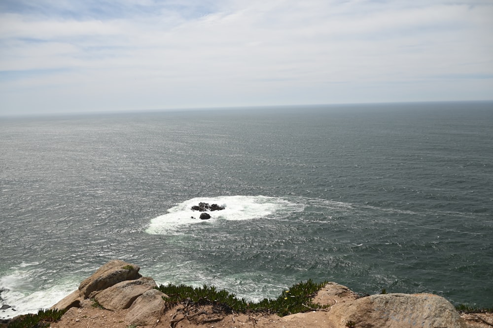 a view of the ocean from the top of a hill