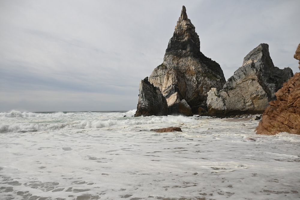 a rock formation in the middle of a body of water