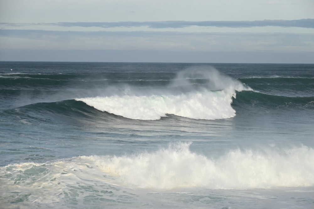 a person riding a wave on top of a surfboard