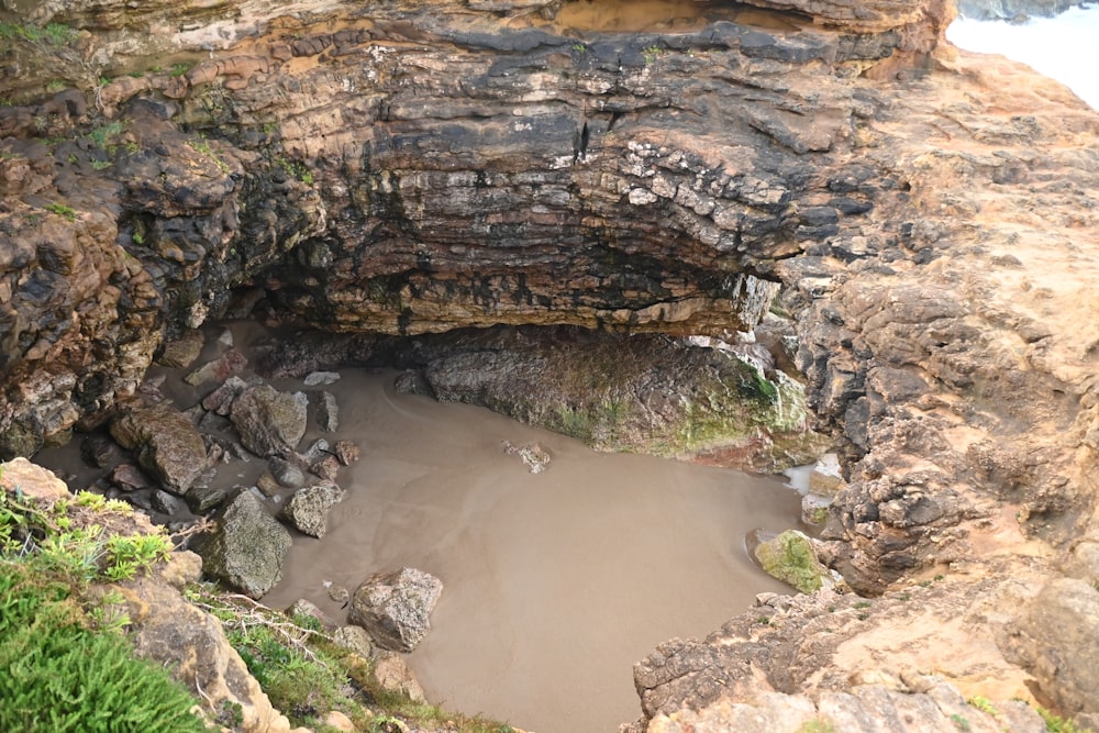 a small hole in the side of a cliff