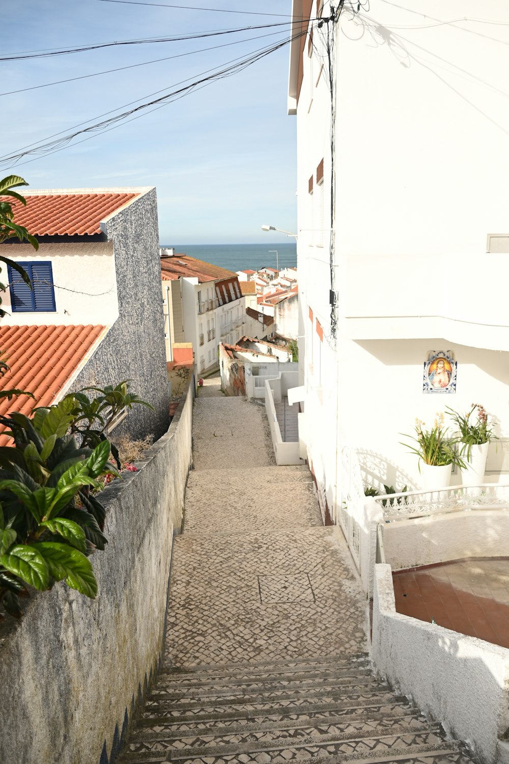 a cobblestone street leading to a beach