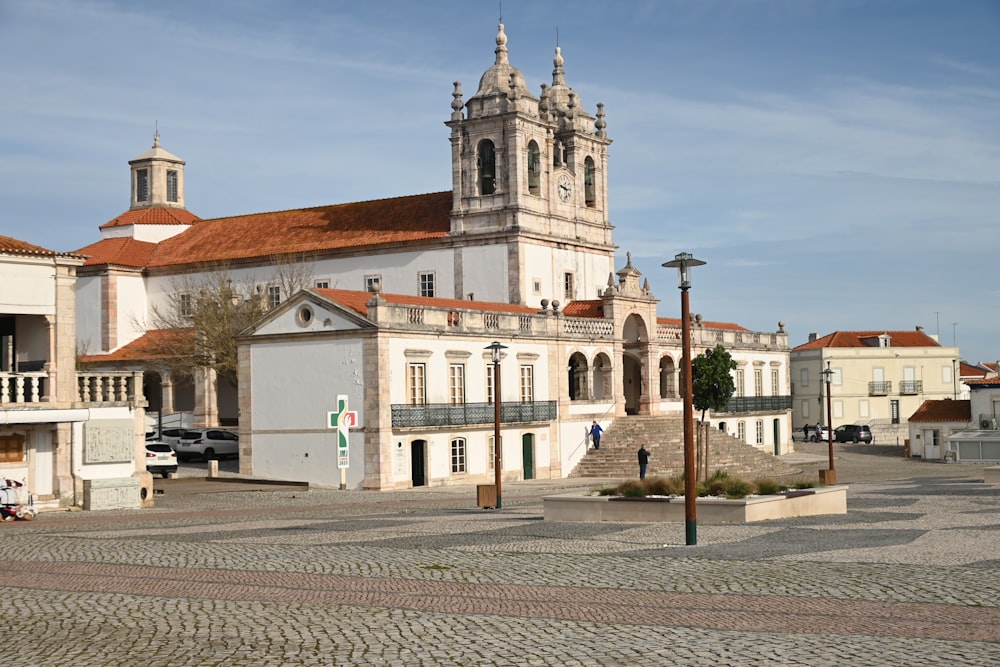 a large white building with a clock tower