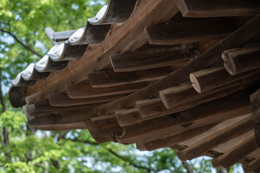 a close up of a wooden structure with trees in the background