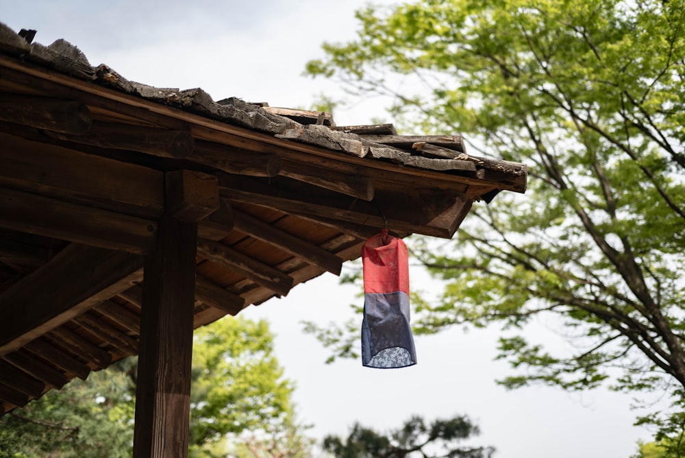 a blue and red flag hanging from a roof