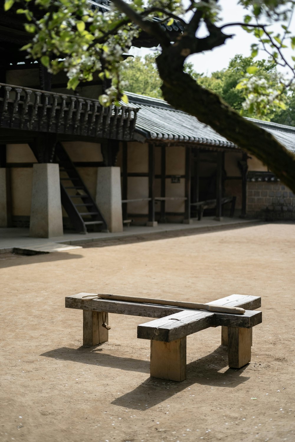 a wooden bench sitting in front of a building