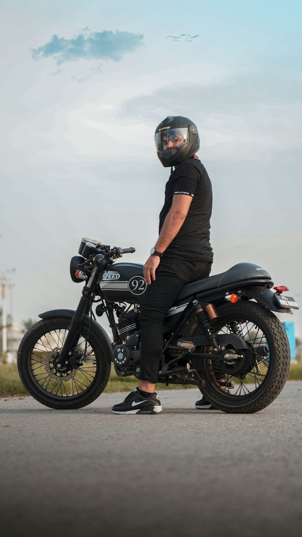 a man wearing a helmet sitting on a motorcycle