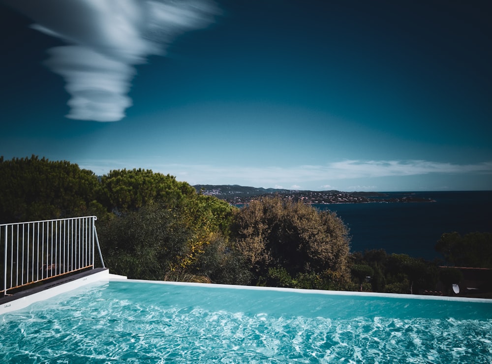 a swimming pool with a view of the ocean