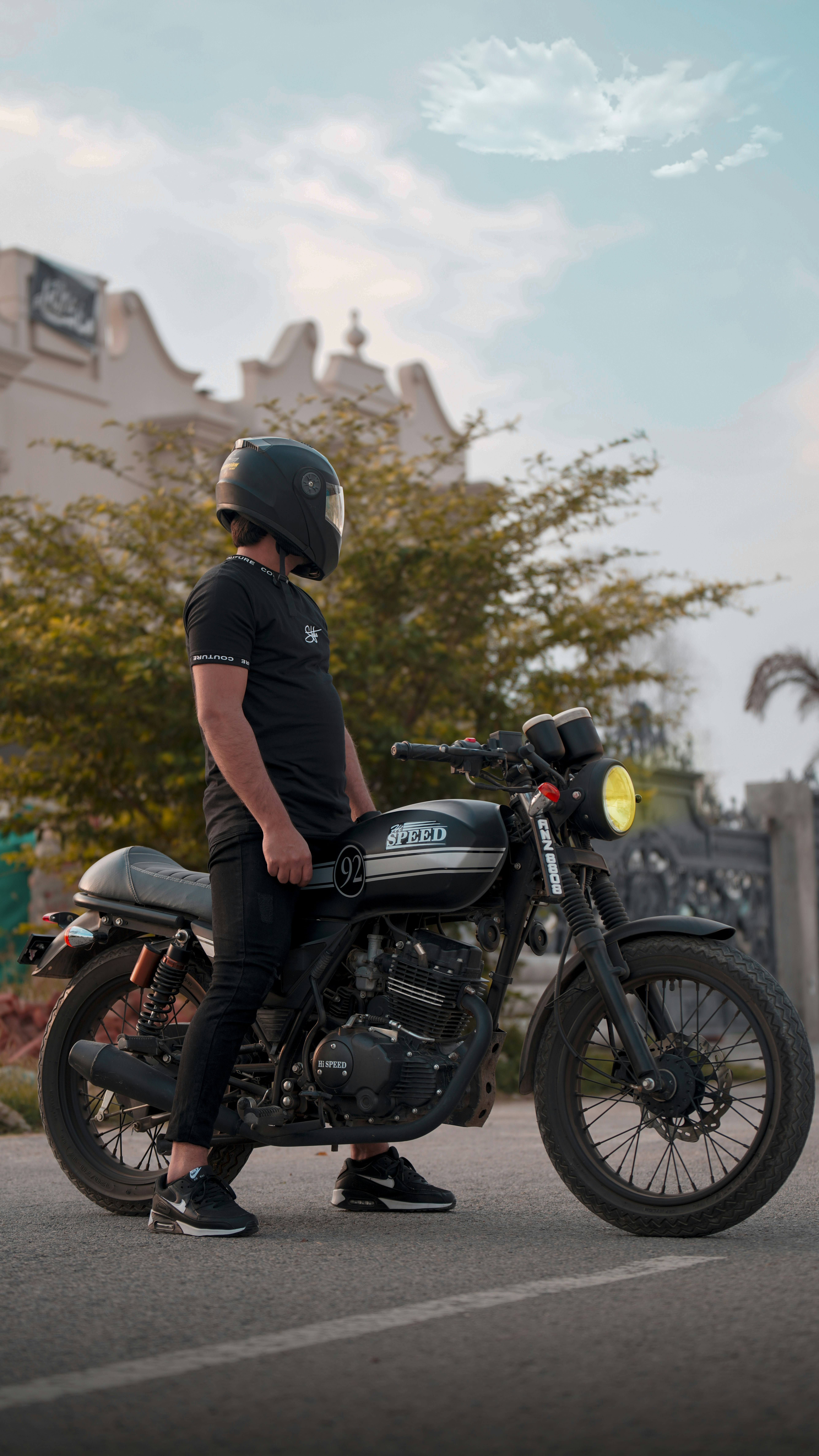 a man wearing a helmet sitting on a motorcycle