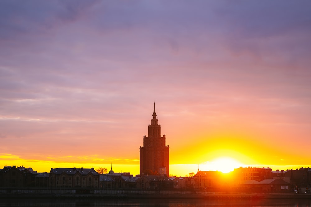 the sun is setting over a large city