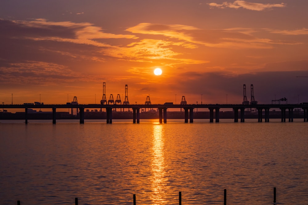 the sun is setting over a large body of water