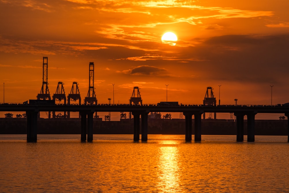 the sun is setting over a large body of water