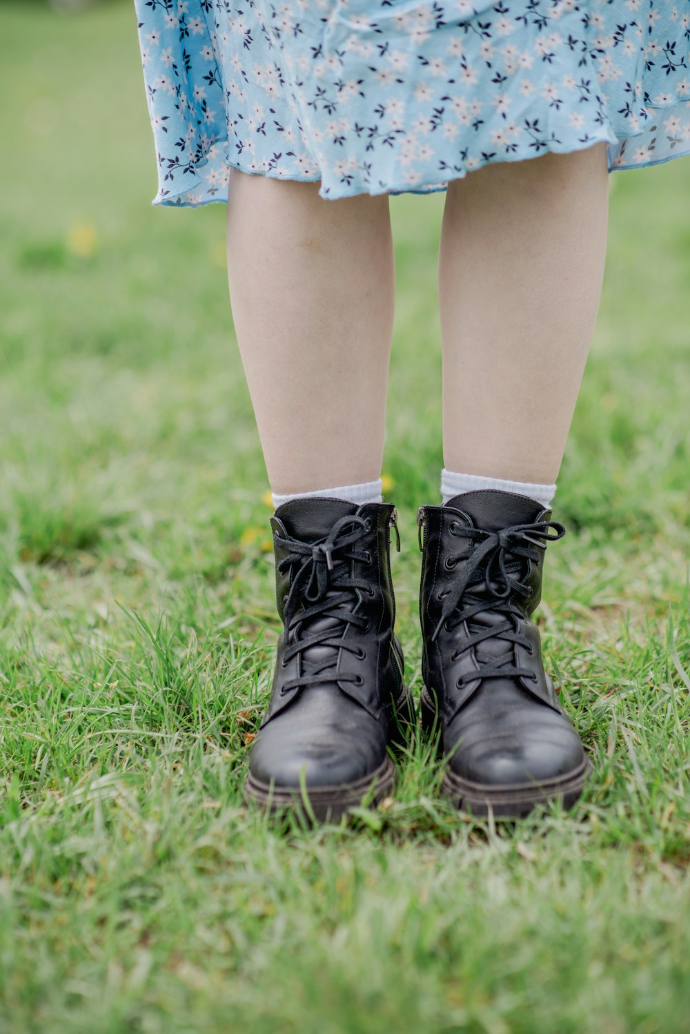 a close up of a person wearing black boots