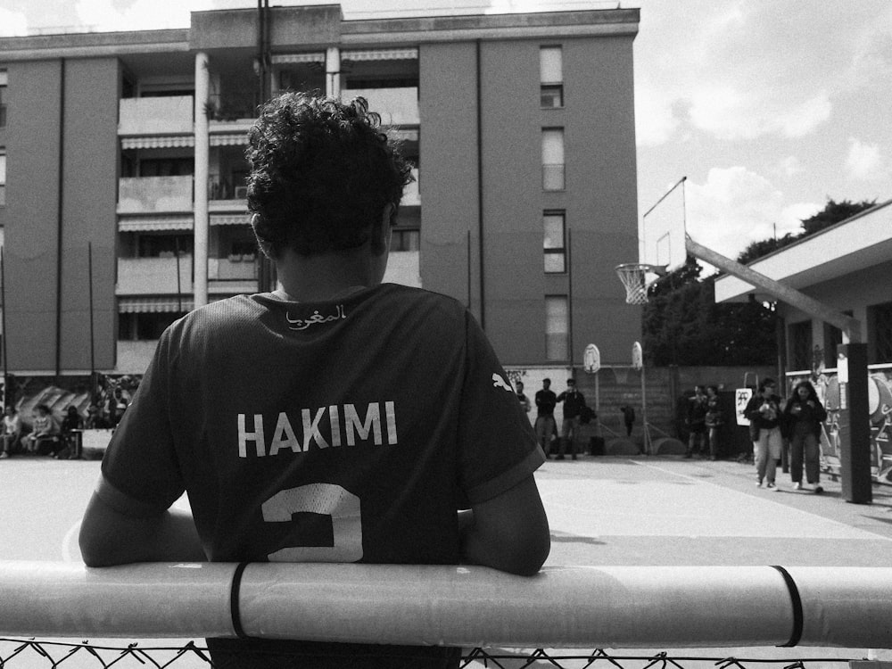 a person sitting on a bench in front of a building