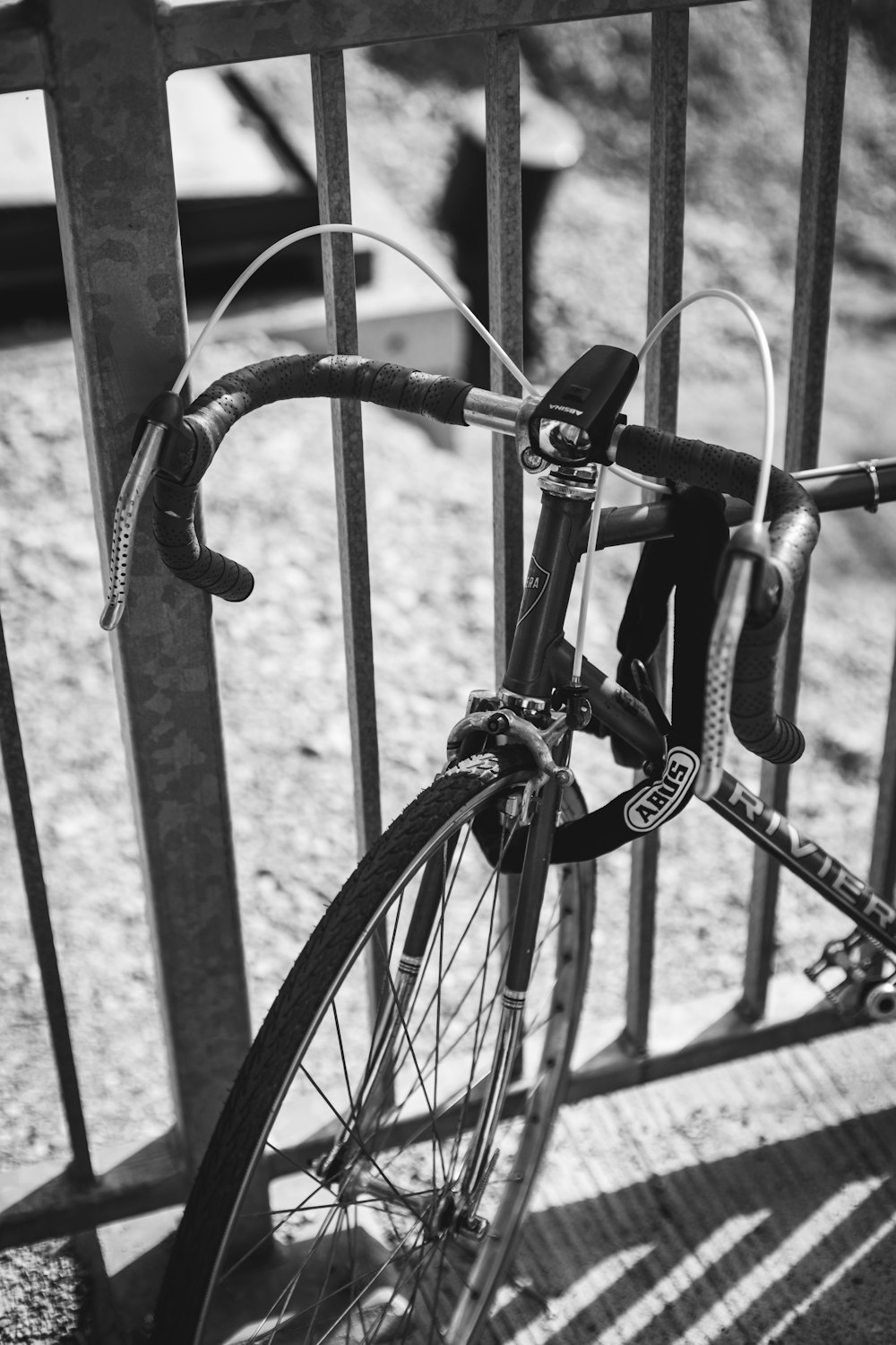 a bicycle locked to a metal fence
