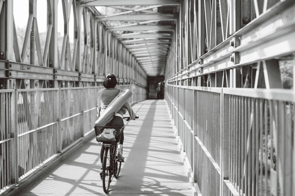 a person riding a bike on a bridge