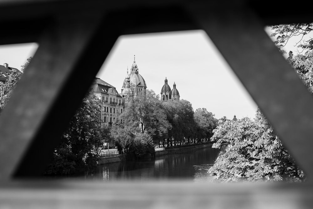 a black and white photo of a river and buildings