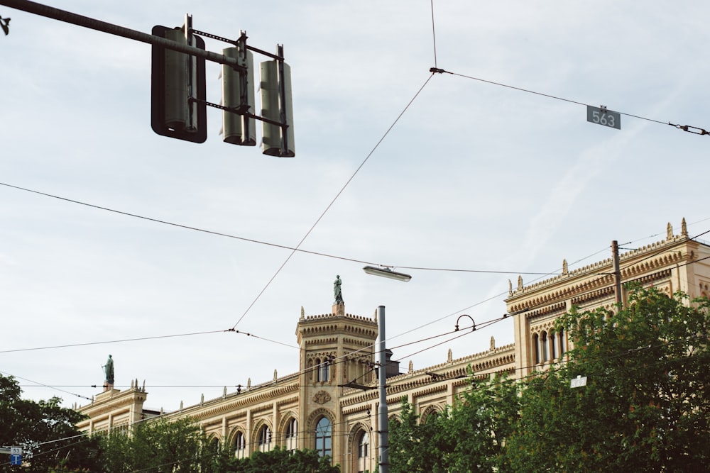 a traffic light hanging over a street next to a tall building