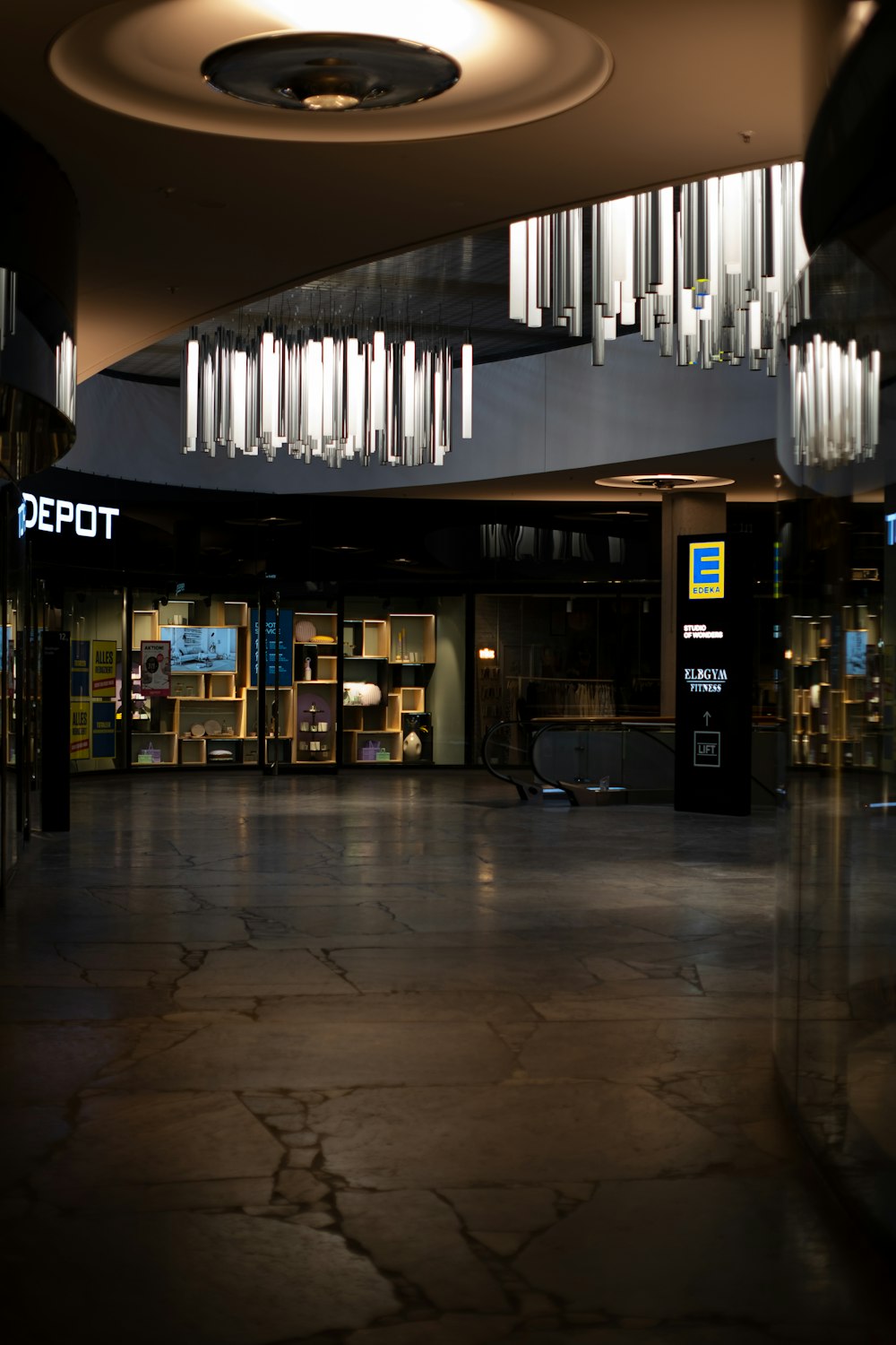 a large room with a circular light fixture hanging from the ceiling