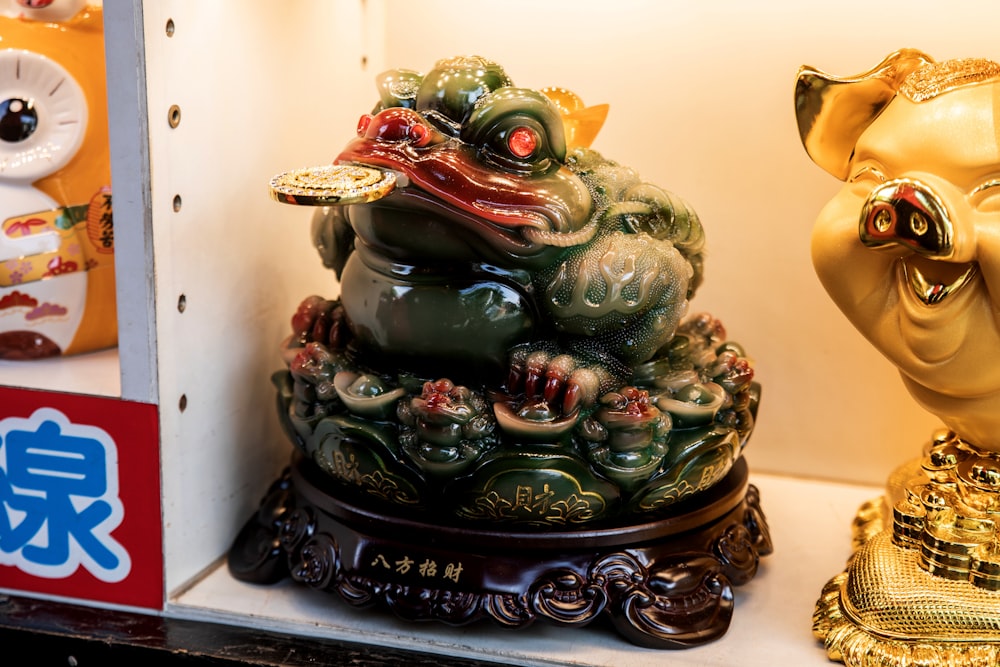 a close up of two statues of animals on a shelf