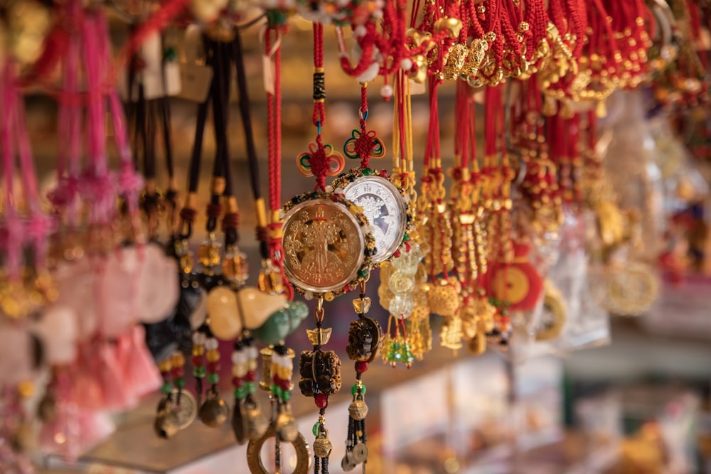 a bunch of necklaces hanging on a wall