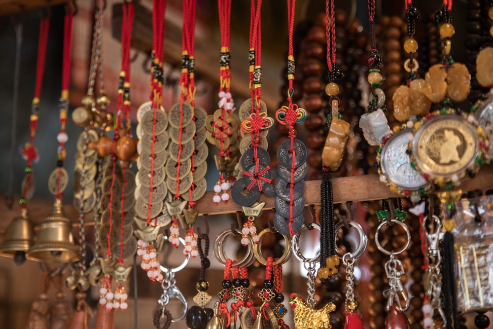 a bunch of necklaces hanging on a wall