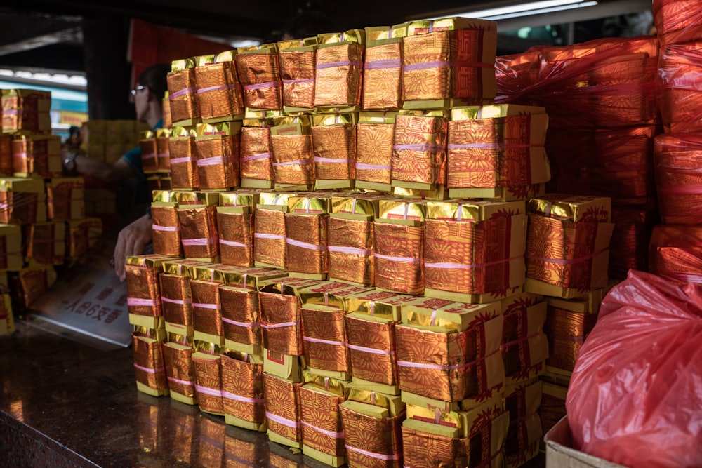 a stack of orange wrapped packages sitting on top of a counter