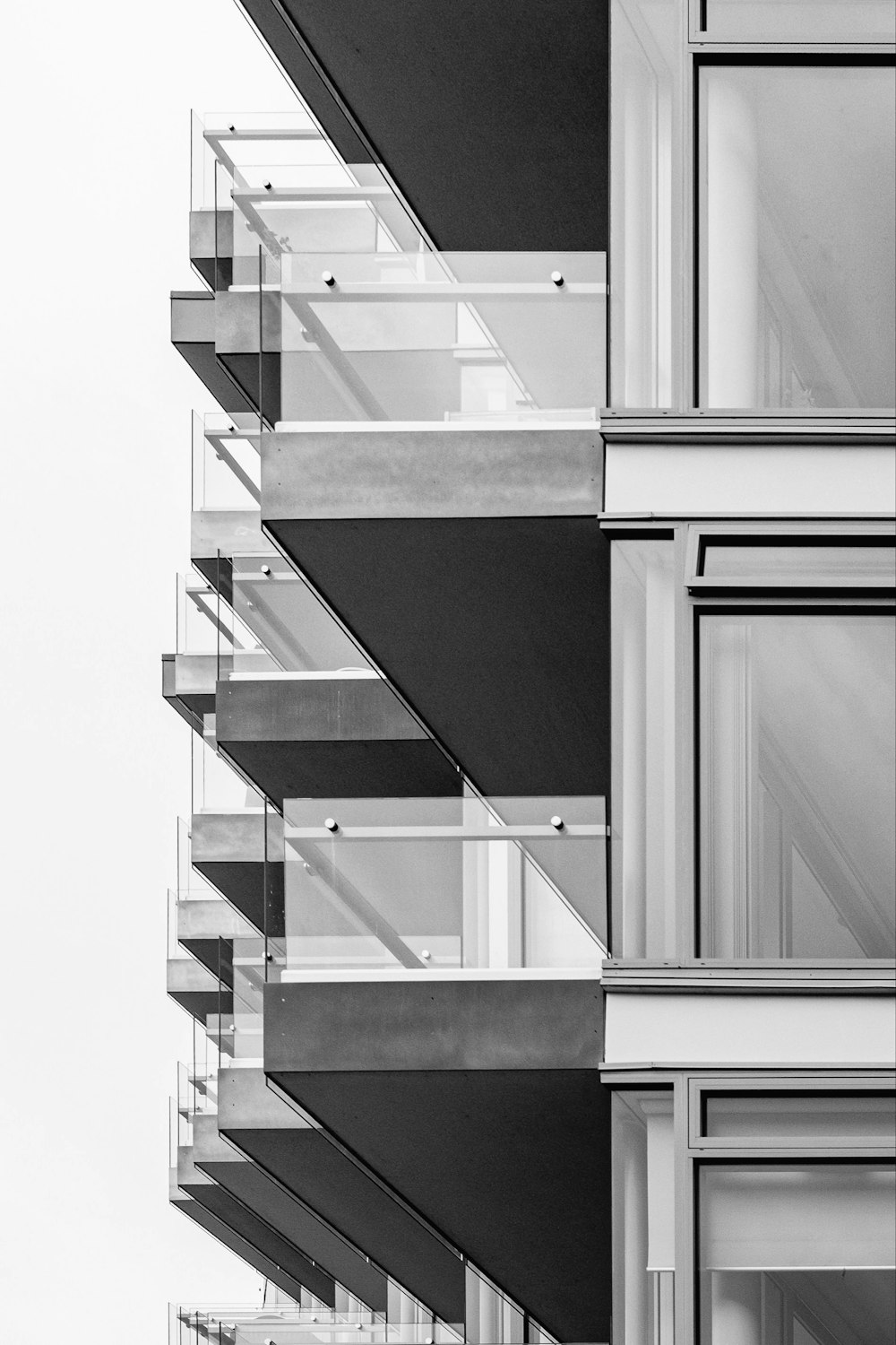 a black and white photo of a building with balconies