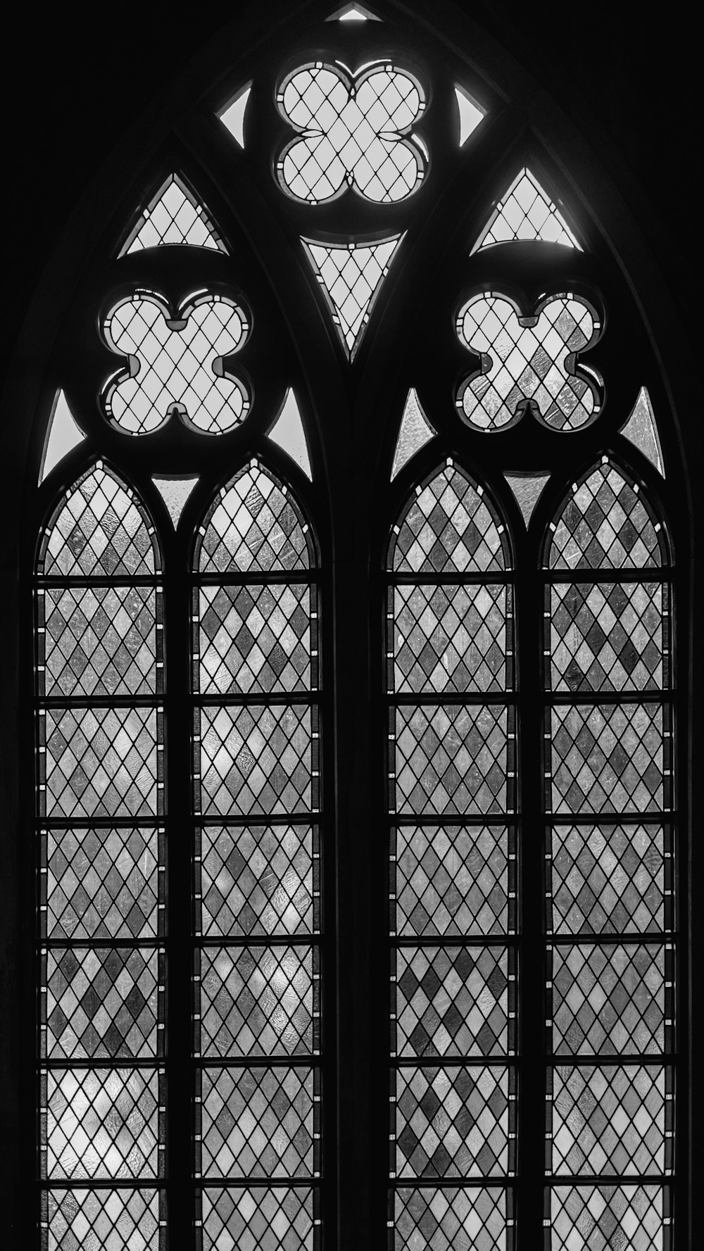 a black and white photo of a stained glass window