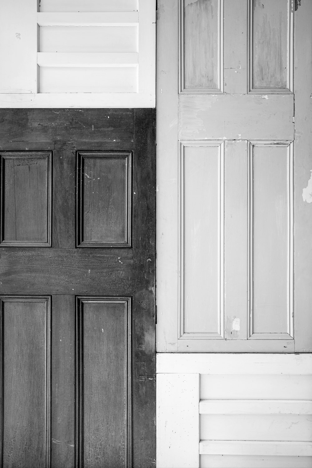 a black and white photo of a wooden door